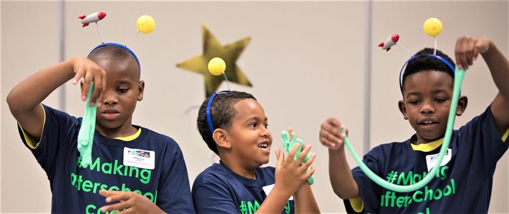Three CASE for Kids afterschool program children playing with slime.