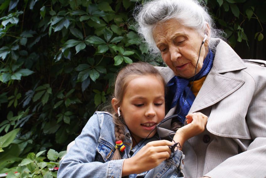  Image of a senior citizen sharing a moment with a child.