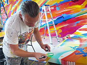  This is a screenshot of the artist working on the mural