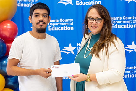  This is an image of a scholarship winner receiving his check from EFHC